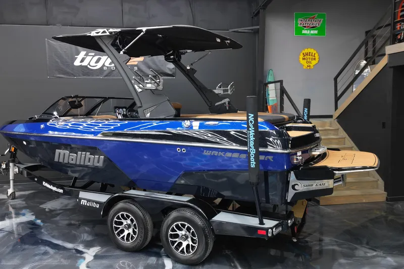 Slide: The Image of 2021 Malibu Wakesetter 20 VTX boat in showroom, blue exterior, on trailer. - 3