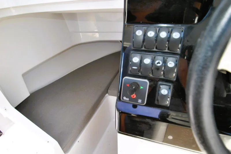 Slide: The Image of Interior view of 2019 Jeanneau NC 795 Sport boat, featuring control panel and seating area. - 10