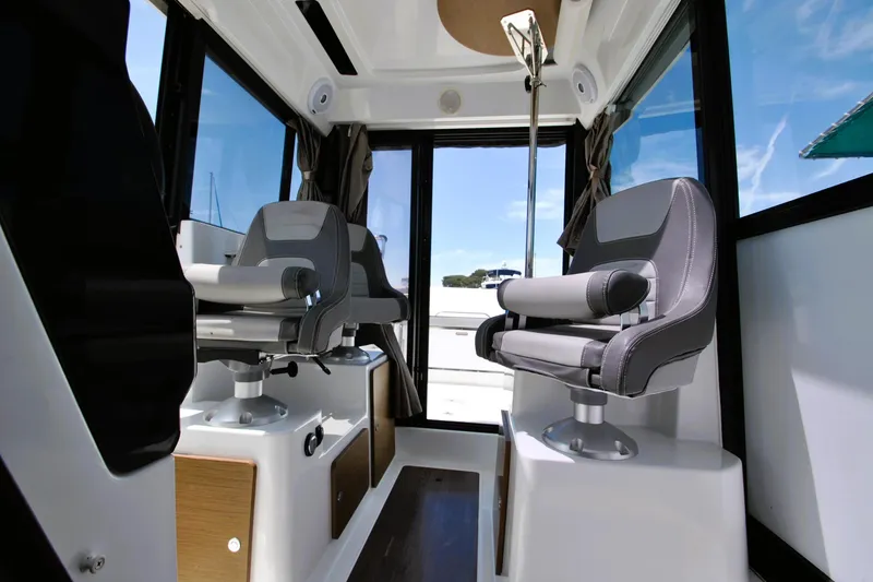 Slide: The Image of Interior of 2019 Jeanneau NC 795 Sport boat with modern seating and panoramic windows. - 14