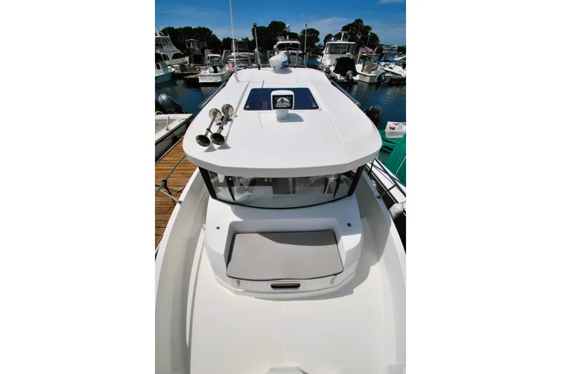 Slide: The Image of 2019 Jeanneau NC 795 Sport boat docked in a marina, top view. - 21