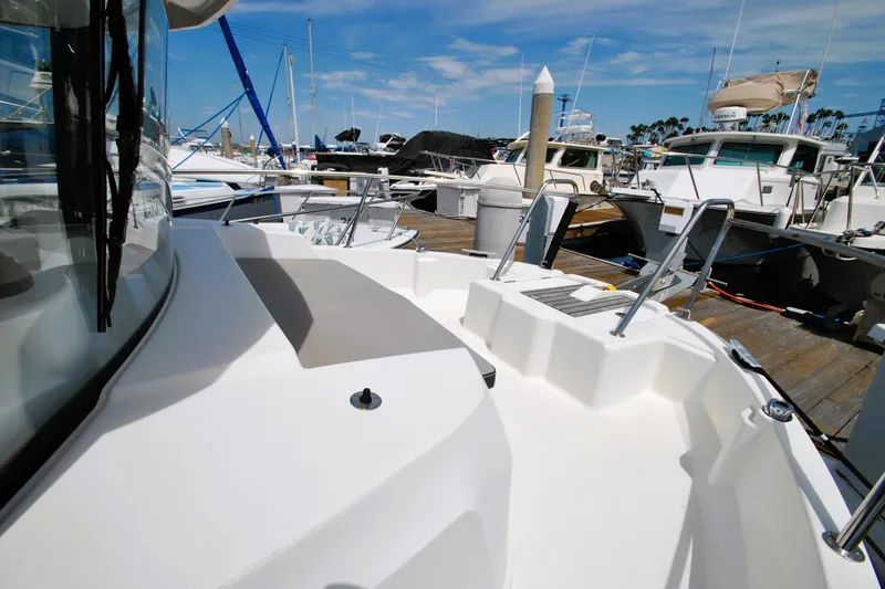 Slide: The Image of 2019 Jeanneau NC 795 Sport docked at marina under clear blue sky. - 22
