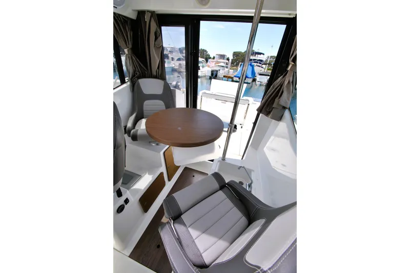 Slide: The Image of Interior of 2019 Jeanneau NC 795 Sport boat with seating and table. - 23