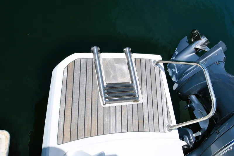 Slide: The Image of 2019 Jeanneau NC 795 Sport swim platform with ladder and outboard motor. - 31