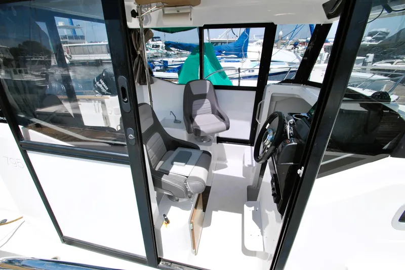Slide: The Image of Interior view of 2019 Jeanneau NC 795 Sport boat, featuring helm and seating area. - 5