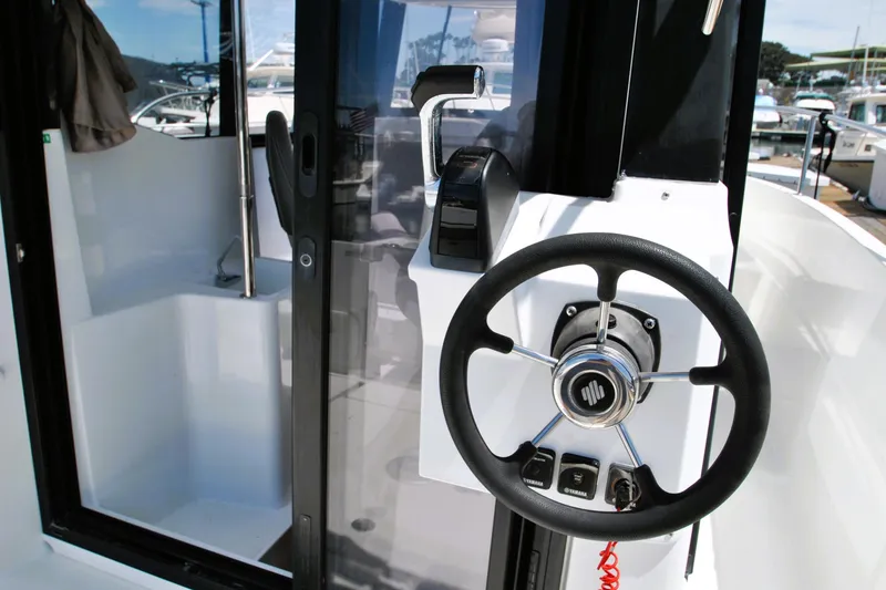 Slide: The Image of Steering wheel and controls of 2019 Jeanneau NC 795 Sport boat. - 7