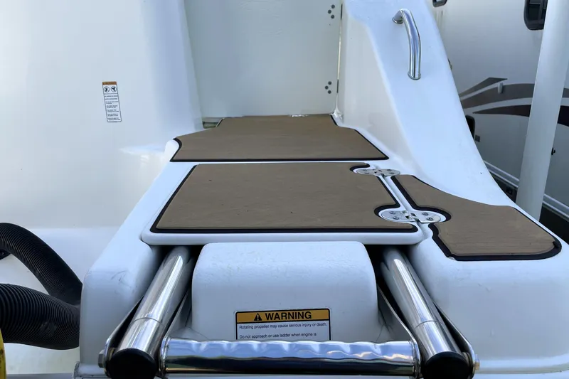 Slide: The Image of 2020 NauticStar 28 XS boat deck with non-slip surface and safety warning label. - 11