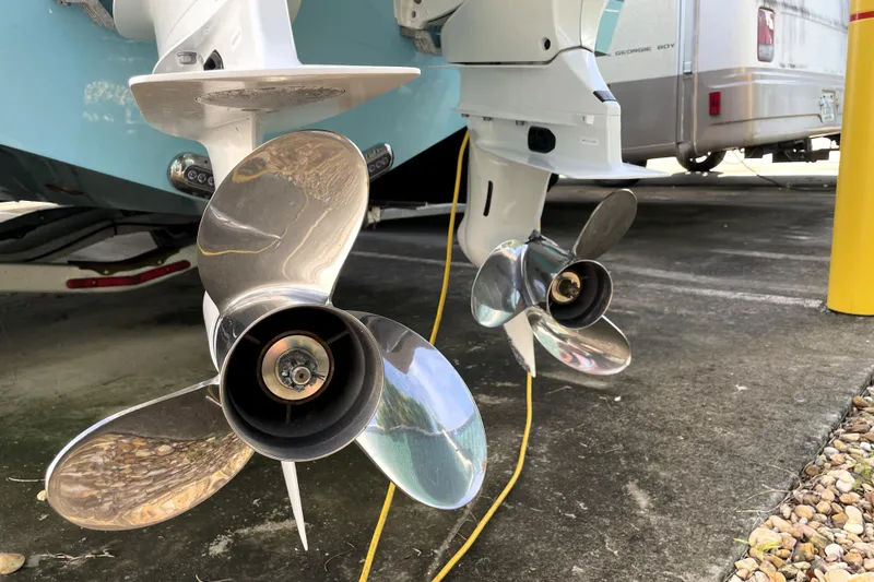 Slide: The Image of 2020 NauticStar 28 XS boat propellers in a parking area. - 13
