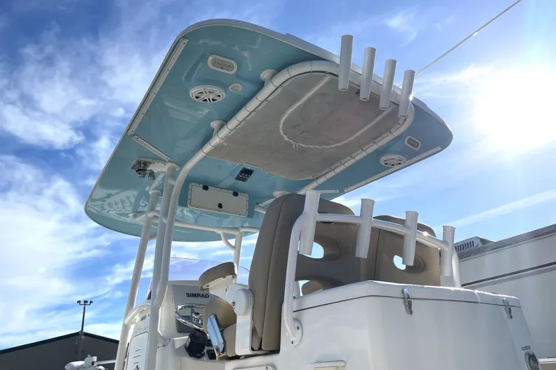 Slide: The Image of 2020 NauticStar 28 XS boat with blue T-top under sunny sky. - 15