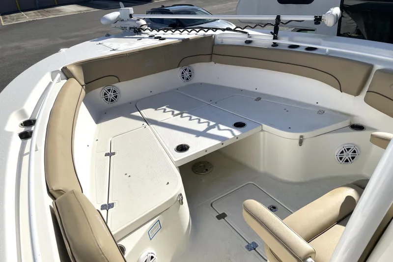 Slide: The Image of 2020 NauticStar 28 XS boat interior with beige seating and fishing rod holders. - 16