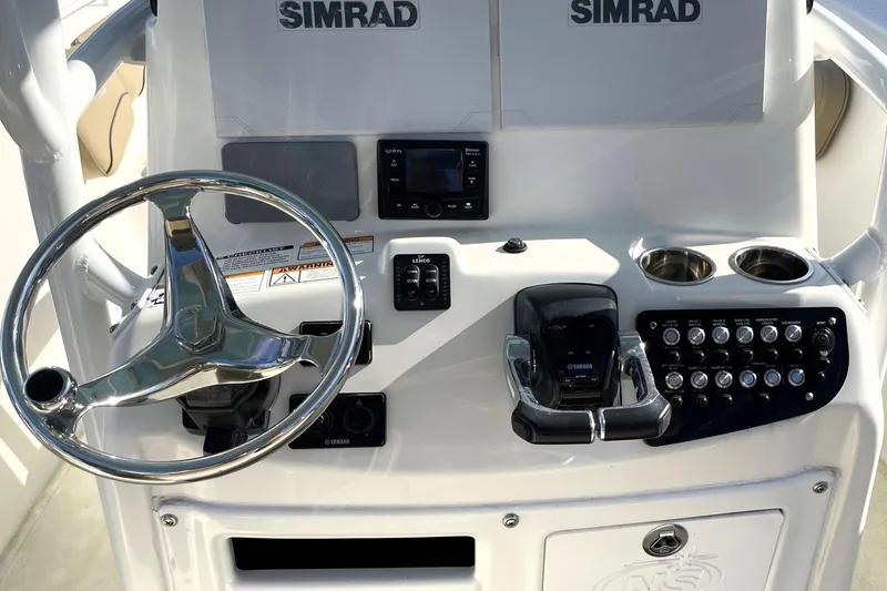 Slide: The Image of Control panel of 2020 NauticStar 28 XS boat with steering wheel and Simrad electronics. - 19