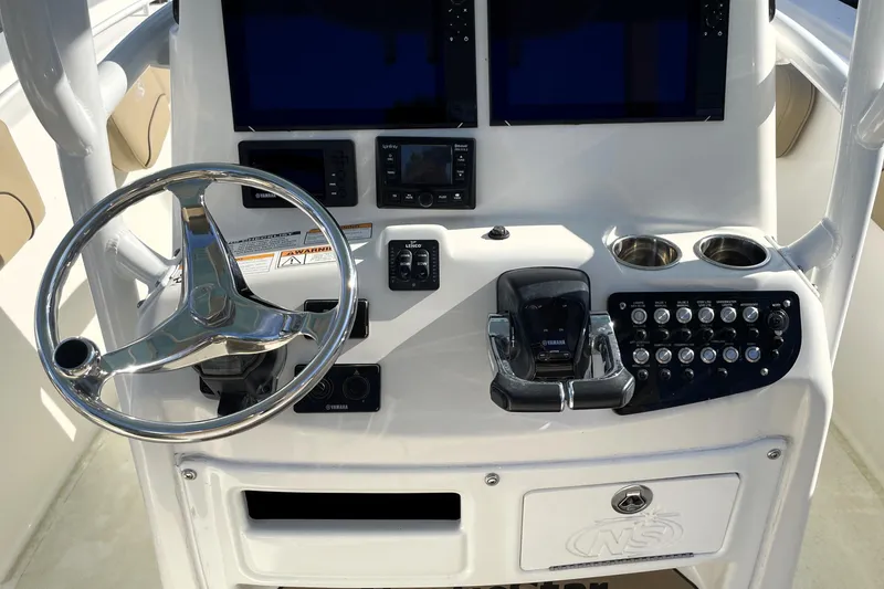 Slide: The Image of 2020 NauticStar 28 XS boat console with steering wheel and controls. - 20