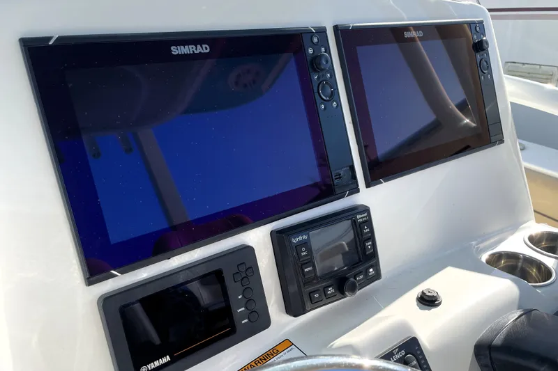 Slide: The Image of Control panel of 2020 NauticStar 28 XS boat with Simrad displays. - 21