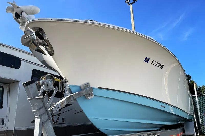 Slide: The Image of 2020 NauticStar 28 XS boat on trailer, viewed from below against blue sky. - 7