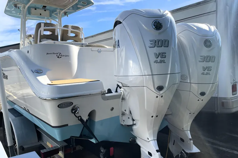 Slide: The Image of 2020 NauticStar 28 XS boat with twin Yamaha 300 V6 engines on trailer. - 9