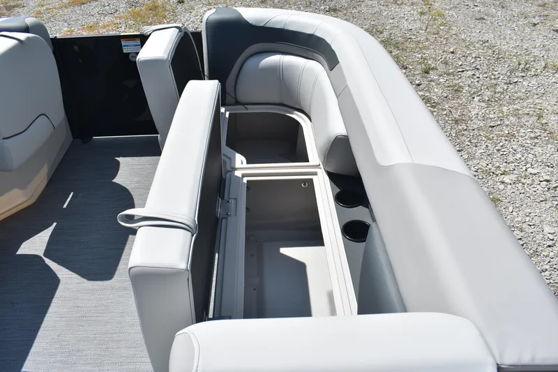 Slide: The Image of 2026 Godfrey SWEETWATER 2086SB boat interior with open storage compartment and cup holders. - 19
