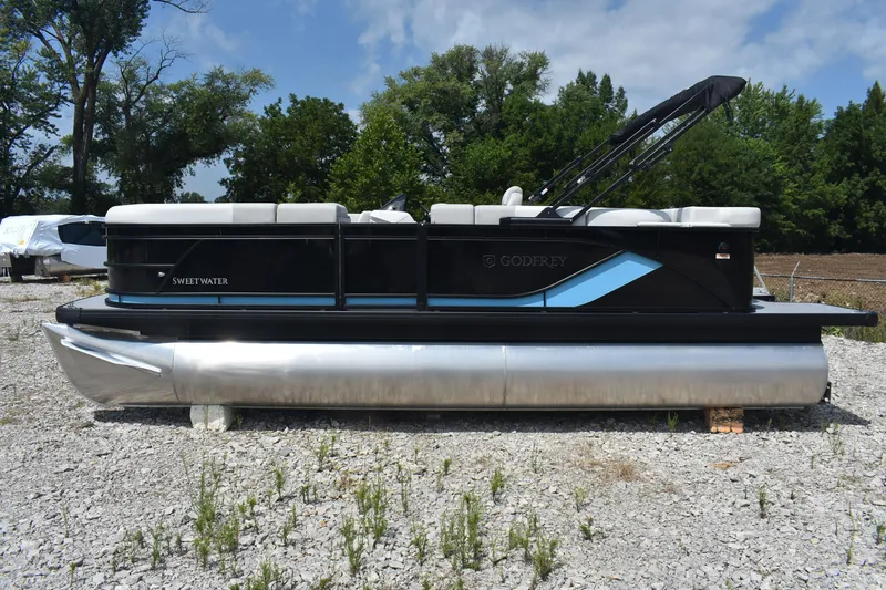 Slide: The Image of 2026 Godfrey SWEETWATER 2086SB pontoon boat on gravel, surrounded by trees. - 3