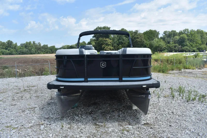 Slide: The Image of 2026 Godfrey SWEETWATER 2086SB pontoon boat on gravel, surrounded by greenery. - 4