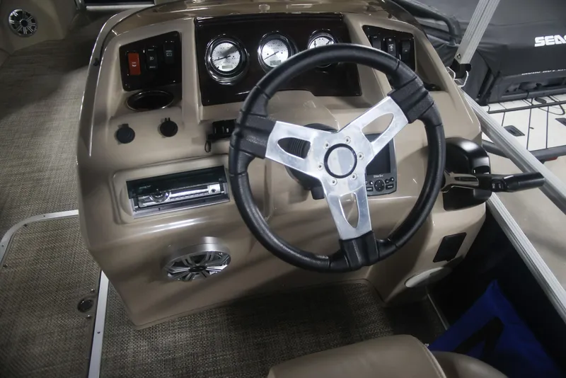Slide: The Image of 2015 Bennington 24 SSLX boat dashboard with steering wheel and gauges. - 10