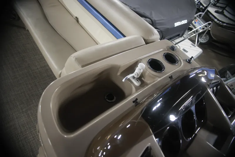 Slide: The Image of Interior of a 2015 Bennington 24 SSLX boat with cup holders and seating. - 12