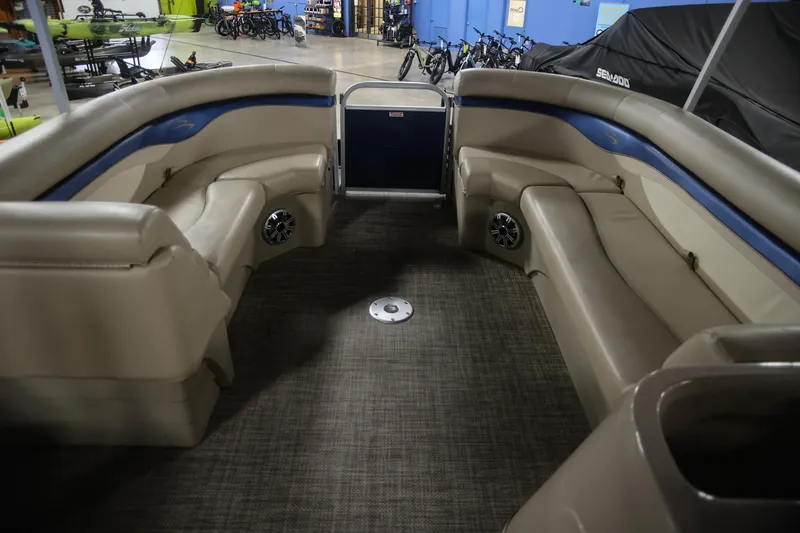 Slide: The Image of Interior of a 2015 Bennington 24 SSLX pontoon boat with beige seating. - 13