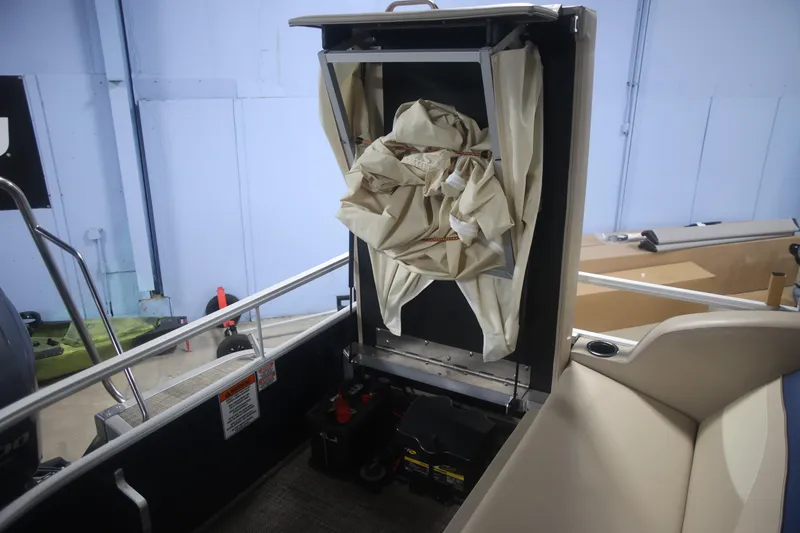 Slide: The Image of 2015 Bennington 24 SSLX boat interior with storage compartment and equipment. - 16