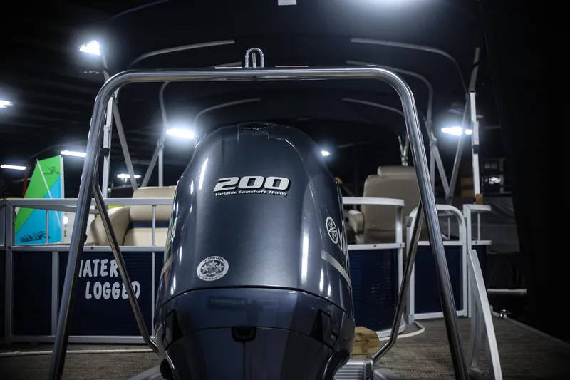 Slide: The Image of 2015 Bennington 24 SSLX pontoon boat with 200 horsepower engine, displayed indoors. - 18