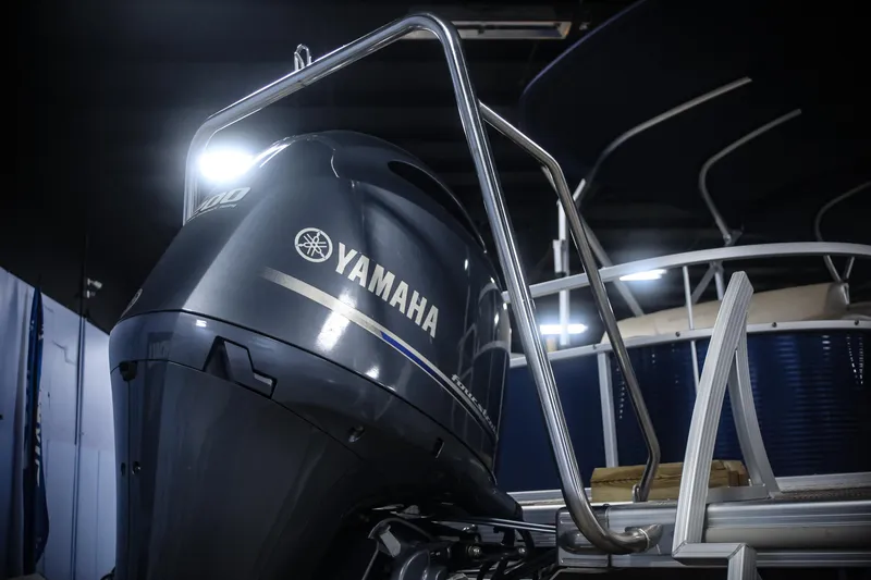 Slide: The Image of 2015 Bennington 24 SSLX with Yamaha outboard motor in a showroom. - 19