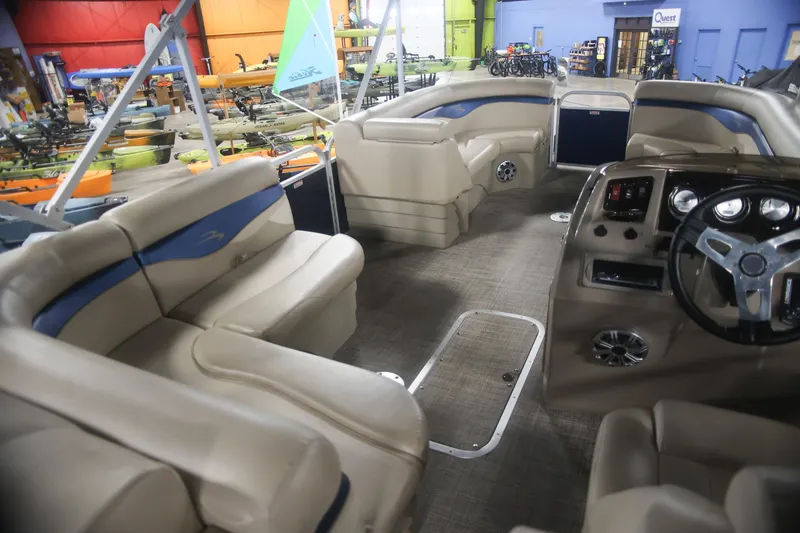 Slide: The Image of Interior of a 2015 Bennington 24 SSLX pontoon boat with beige seating and steering console. - 9