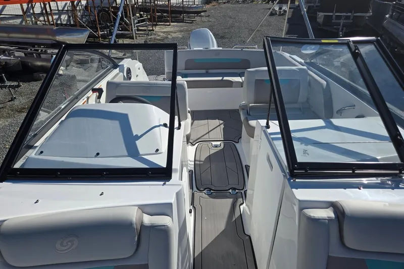 Slide: The Image of 2026 Hurricane SunDeck 235 OB boat interior with open windshield and seating area. - 10