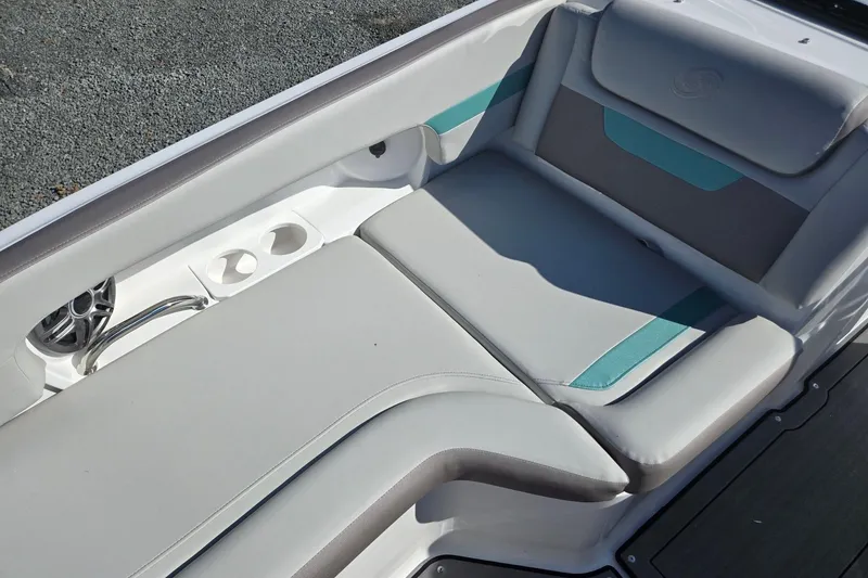 Slide: The Image of 2026 Hurricane SunDeck 235 OB boat interior with cushioned seating and cup holders. - 11