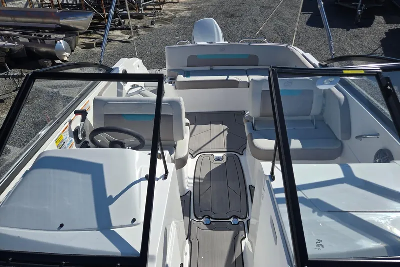 Slide: The Image of 2026 Hurricane SunDeck 235 OB boat interior with seating and steering wheel. - 13