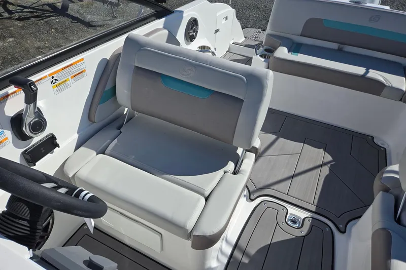 Slide: The Image of 2026 Hurricane SunDeck 235 OB boat interior with gray seating and modern controls. - 16