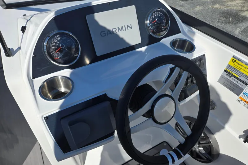 Slide: The Image of 2026 Hurricane SunDeck 235 OB boat dashboard with Garmin display and steering wheel. - 17