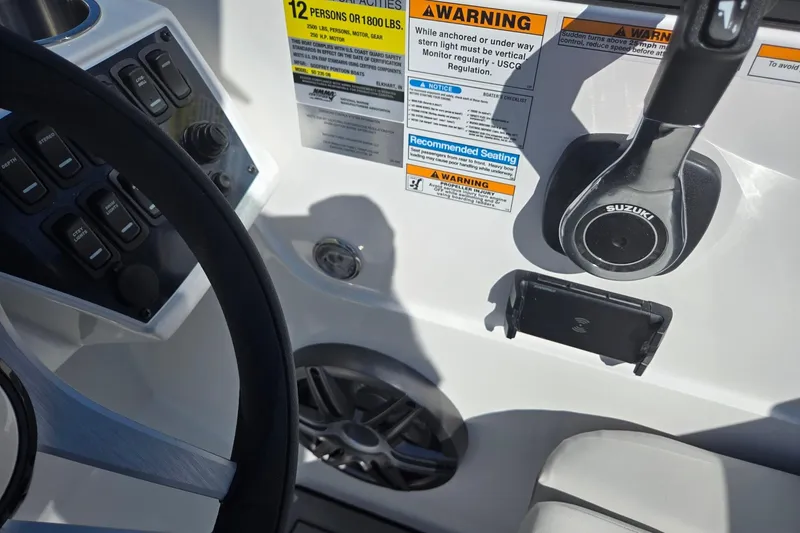 Slide: The Image of 2026 Hurricane SunDeck 235 OB boat dashboard with steering wheel and control panel. - 21
