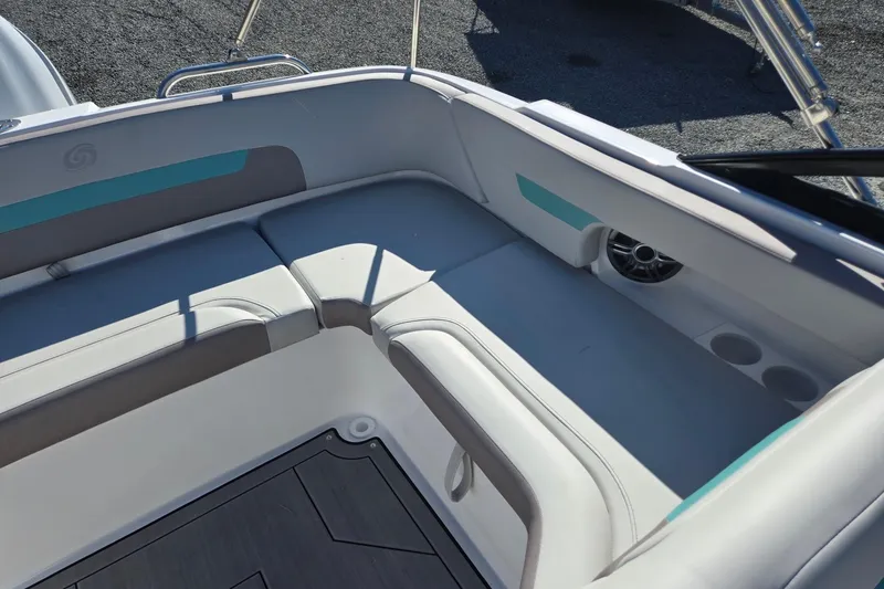 Slide: The Image of 2026 Hurricane SunDeck 235 OB boat interior with cushioned seating and cup holders. - 26