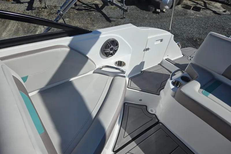 Slide: The Image of 2026 Hurricane SunDeck 235 OB boat interior with seating, cup holders, and speaker. - 27