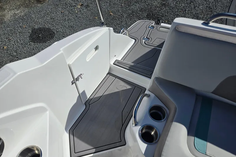 Slide: The Image of 2026 Hurricane SunDeck 235 OB boat interior with cup holders and sleek design. - 28
