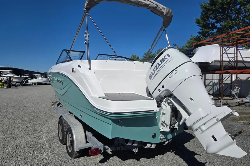 Slide: The Image of 2026 Hurricane SunDeck 235 OB boat with Suzuki outboard motor on trailer. - 3