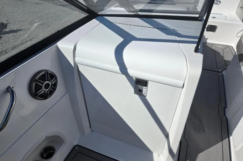 Slide: The Image of 2026 Hurricane SunDeck 235 OB boat interior with speaker and storage compartment. - 37