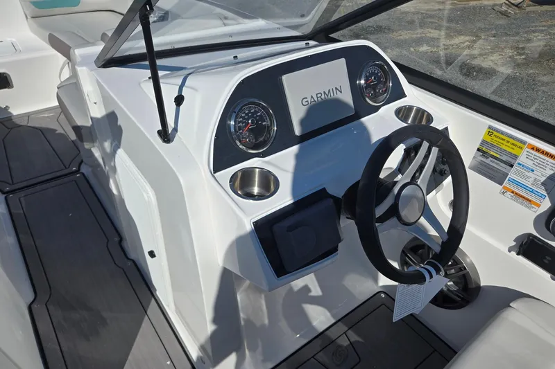 Slide: The Image of 2026 Hurricane SunDeck 235 OB boat dashboard with Garmin navigation and modern controls. - 39