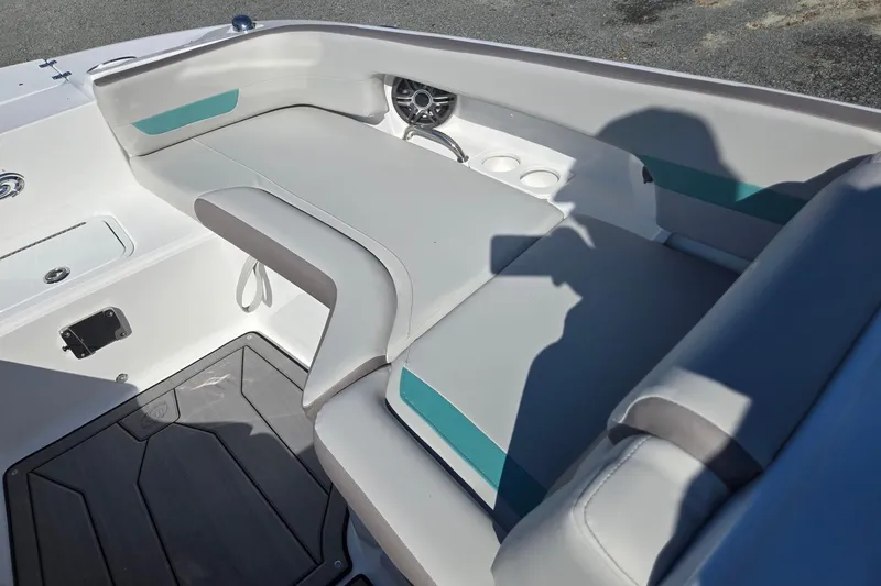 Slide: The Image of 2026 Hurricane SunDeck 235 OB boat interior with cushioned seating and cup holders. - 44