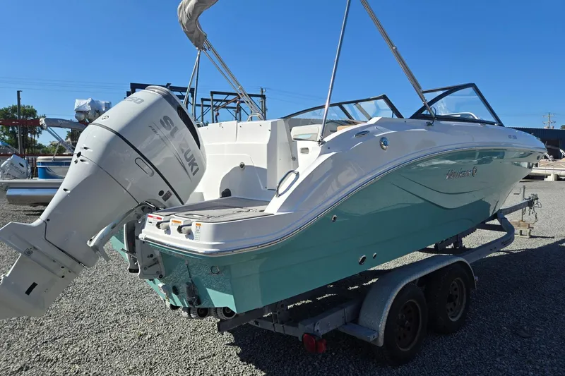 Slide: The Image of 2026 Hurricane SunDeck 235 OB boat on trailer with Suzuki outboard motor. - 5