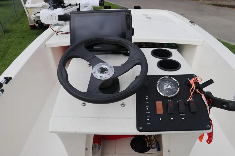 Slide: The Image of 2023 Mako Pro Skiff 13 CC dashboard with steering wheel and control panel. - 12