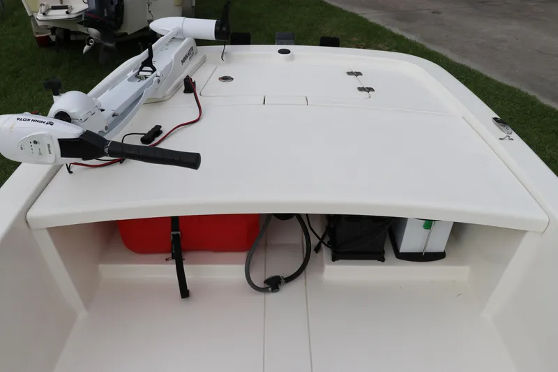 Slide: The Image of 2023 Mako Pro Skiff 13 CC boat deck with trolling motor and storage compartments. - 14