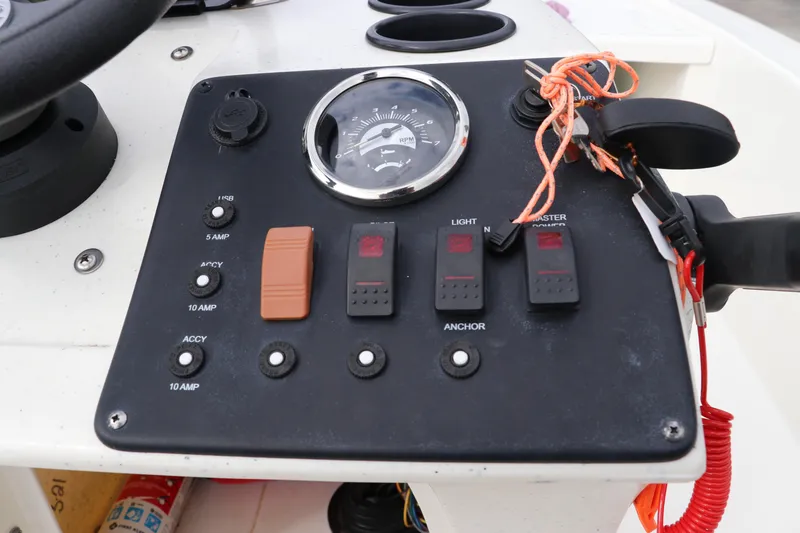 Slide: The Image of Control panel of 2023 Mako Pro Skiff 13 CC boat with switches and RPM gauge. - 19