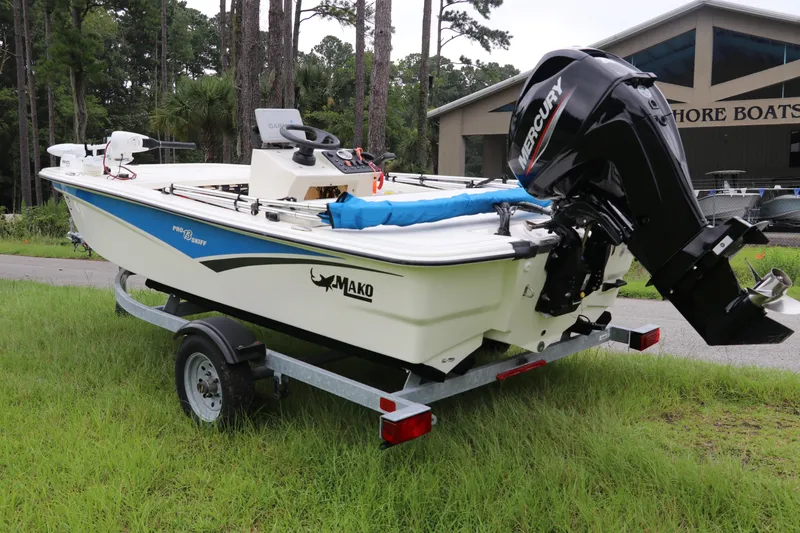 Slide: The Image of 2023 Mako Pro Skiff 13 CC boat with Mercury engine on trailer. - 4