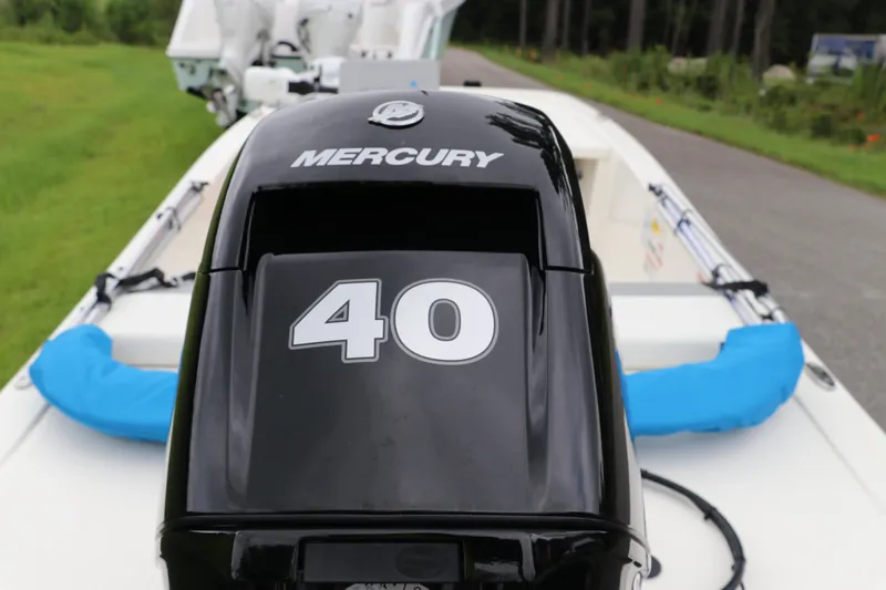 Slide: The Image of 2023 Mako Pro Skiff 13 CC with Mercury 40 HP engine, parked on a road. - 8