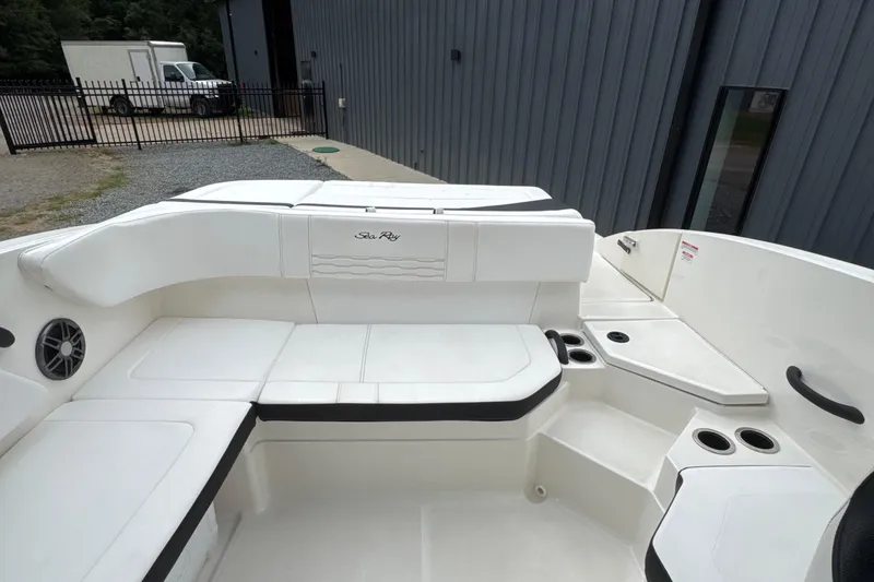 Slide: The Image of 2023 Searay SPX 210 IO boat interior with white seating and cup holders. - 22