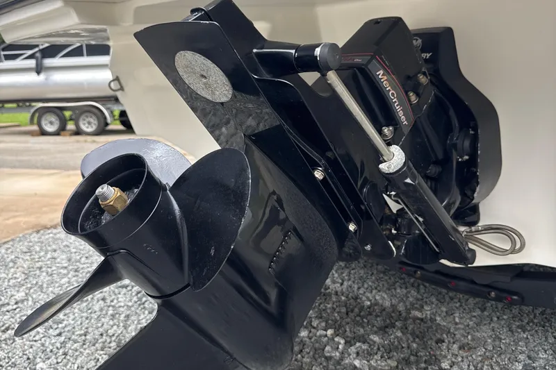 Slide: The Image of 2023 Searay SPX 210 IO boat's MerCruiser engine and propeller detail. - 26