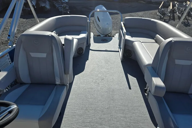 Slide: The Image of 2026 Godfrey Xperience 2286 SBX pontoon boat interior with gray seating and spacious layout. - 13